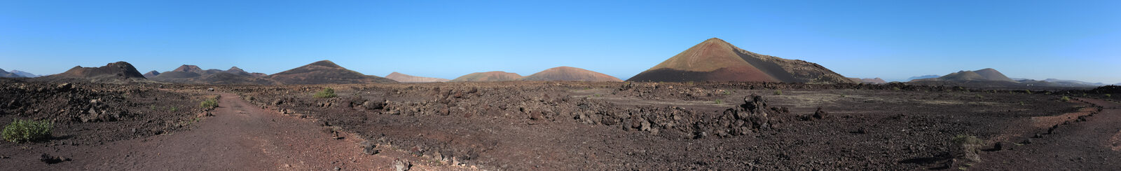 Volcanic landscape of Lanzarote with a whitewashed village on the slope, Canary Islands