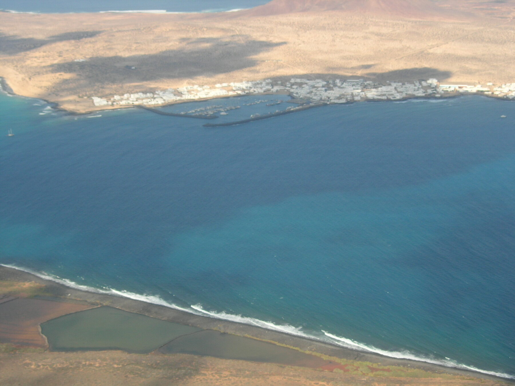 View across the El Río strait between Lanzarote and La Graciosa, with Caleta del Sebo on the far shore