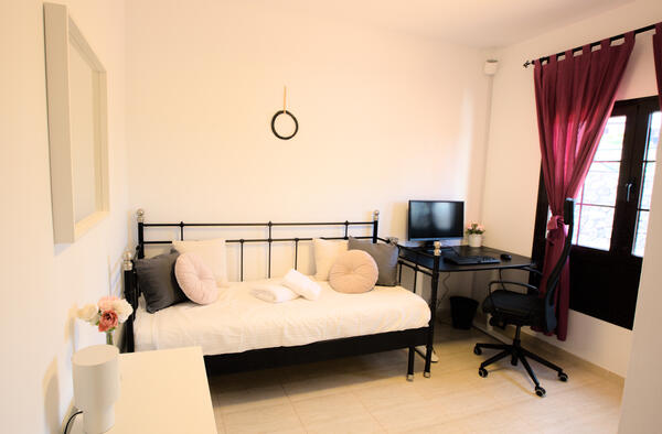 Studio bedroom with daybed, work desk and natural light